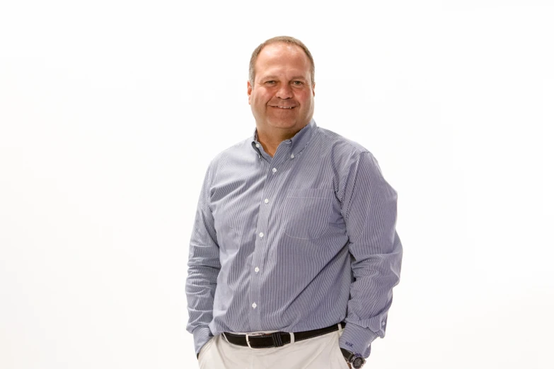 man smiling at camera in shirt with white background