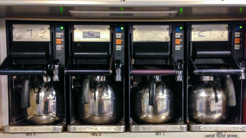 a row of machines displaying three different types of tea