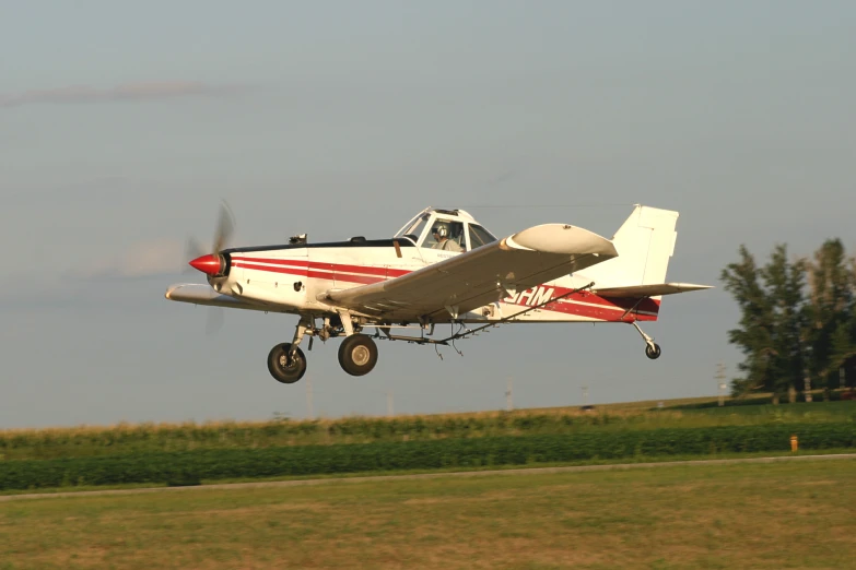 a small plane that is flying low to the ground