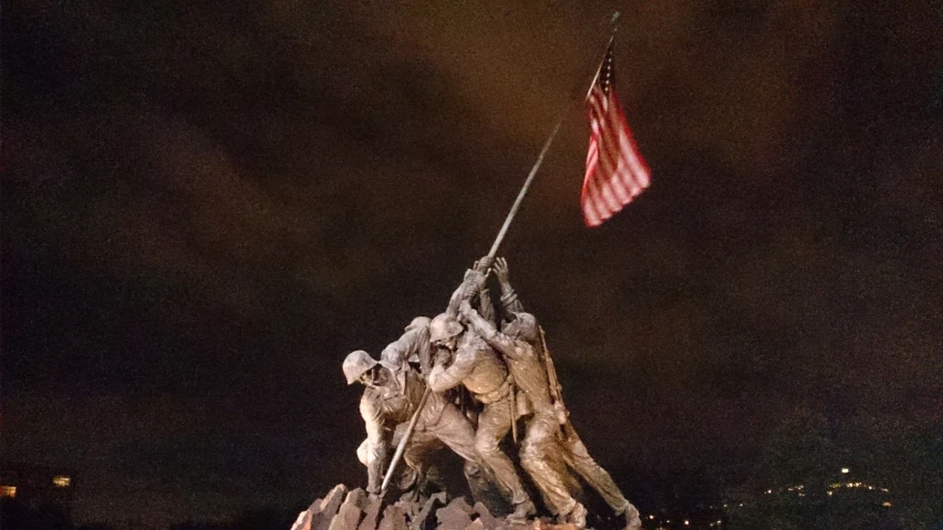 a flag hanging at the base of a large monument