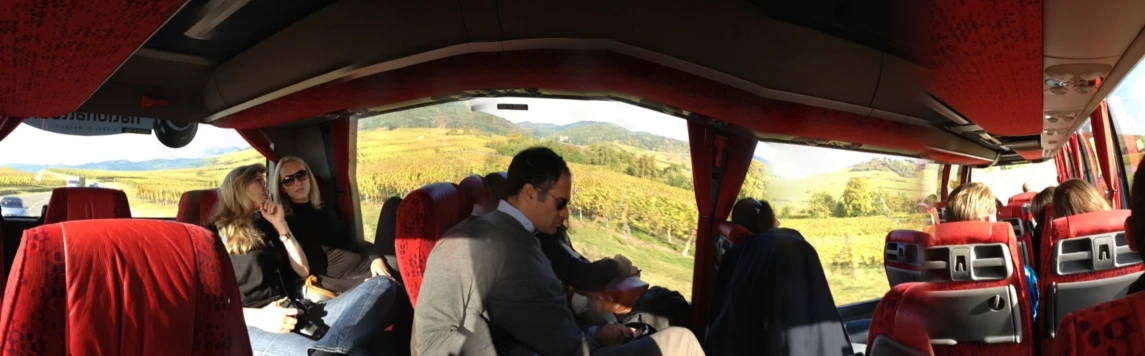 people sitting in the back of a bus on a road