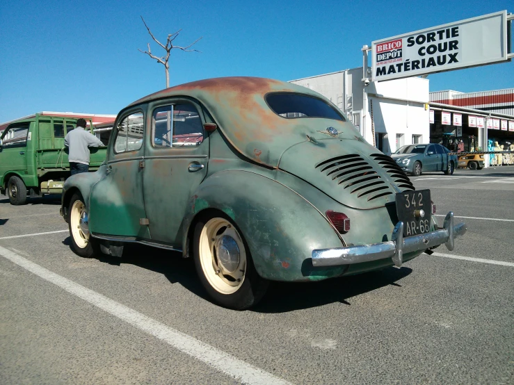 this is an old car parked in a parking lot