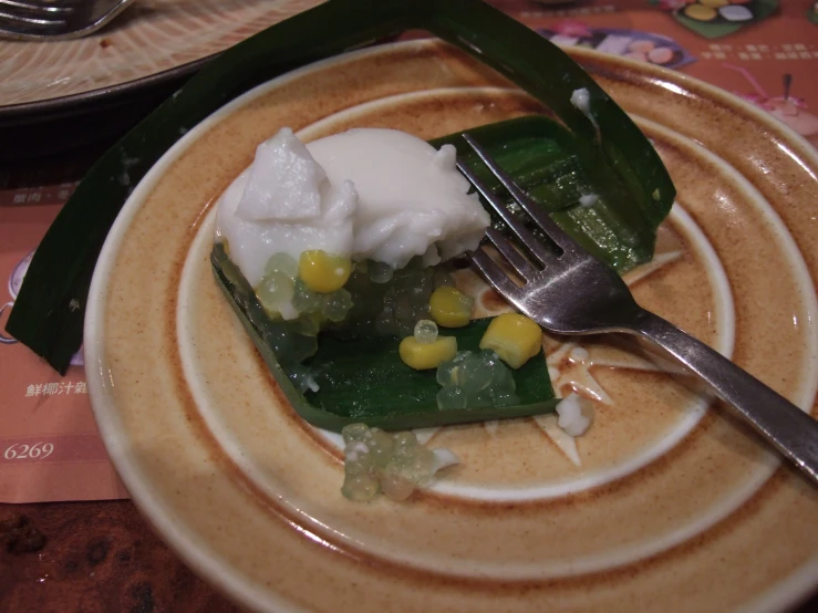 a plate that has some type of dish with corn on it