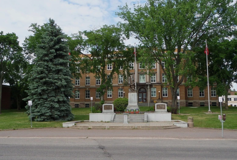 two large concrete benches outside an old building