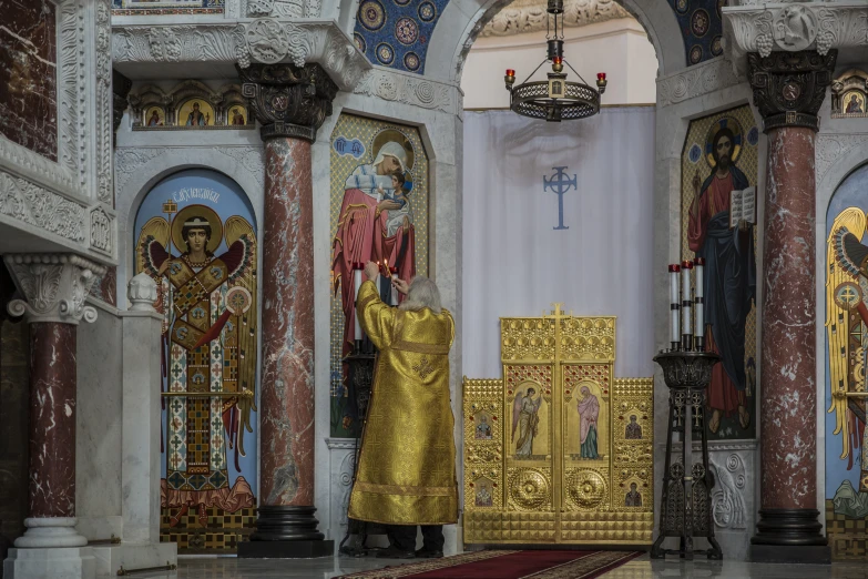 a priest is in a church holding a cross