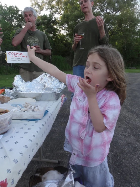 children sitting around a table with food and drinks on it