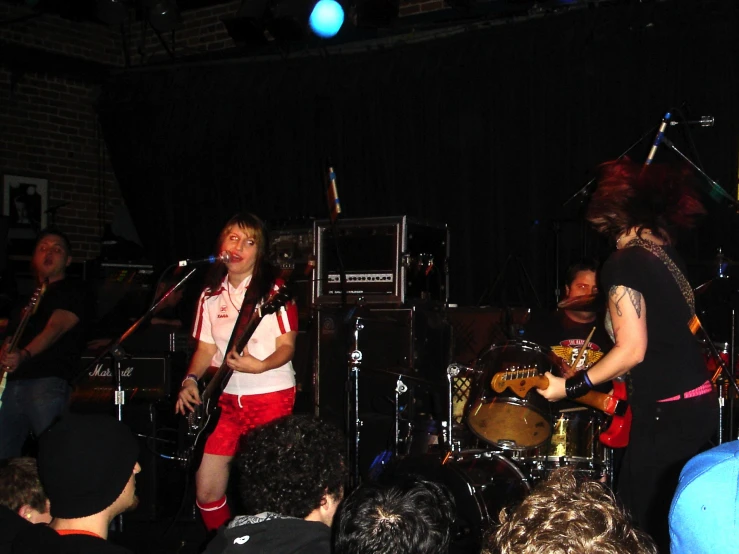 a band playing music on stage and a crowd watching