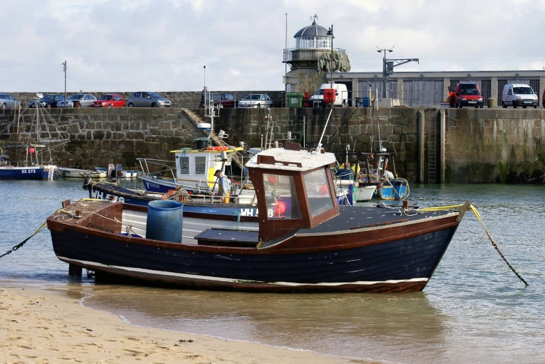 a small fishing boat that is tied up at the shore