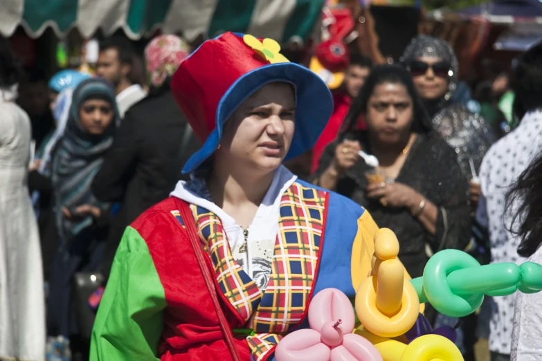 woman in colorful costume with people in background