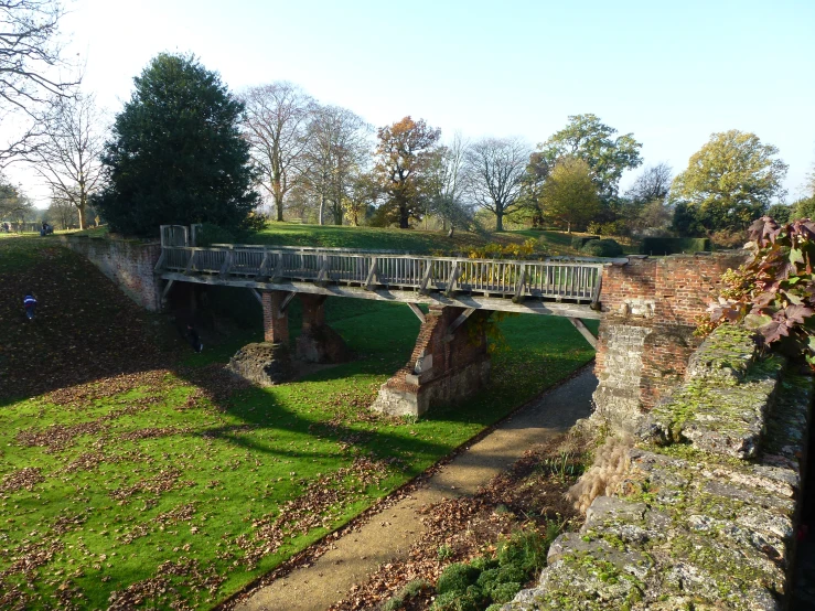 the bridge across the river is next to the path