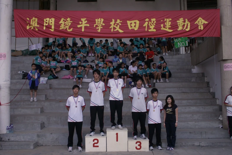 a group of boys in front of a stadium stage