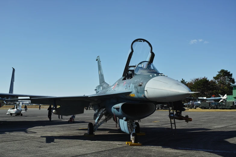 a jet airplane sitting on top of a runway