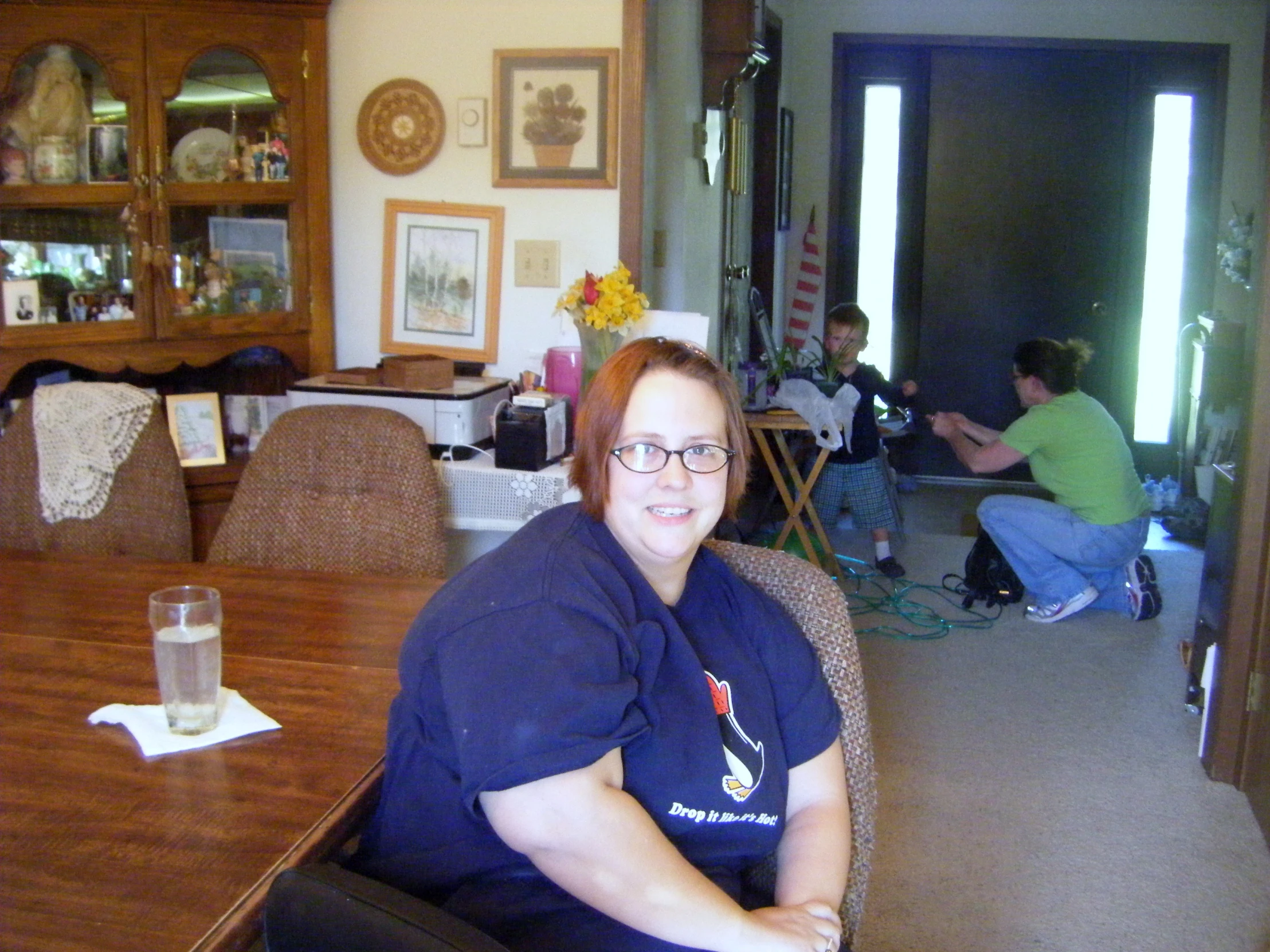 a woman sitting in a chair in the dining room
