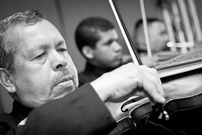 a man in black and white playing the violin