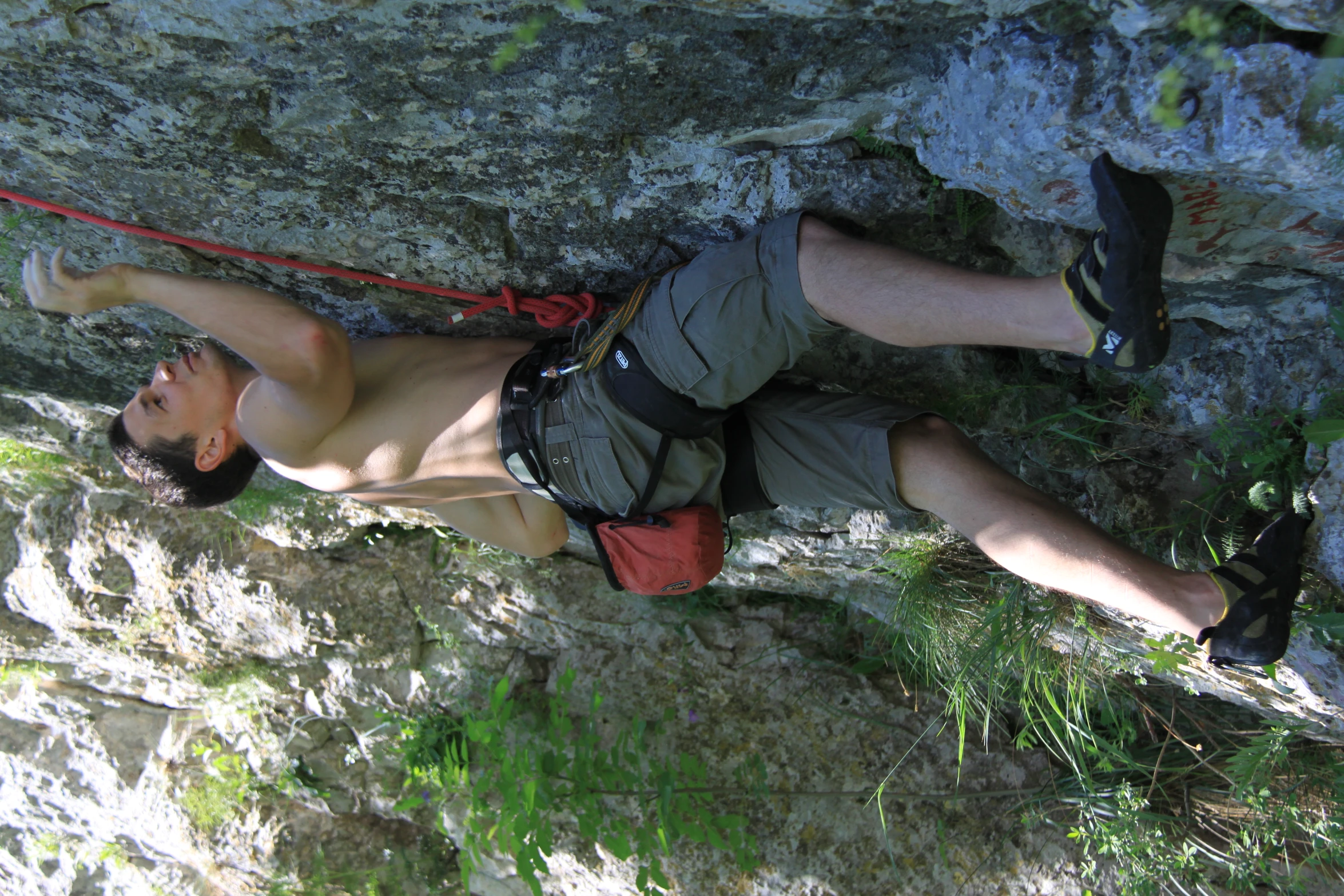 a man on the side of a rock climbing