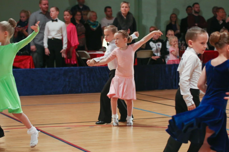 two little girls dancing with arms in the air