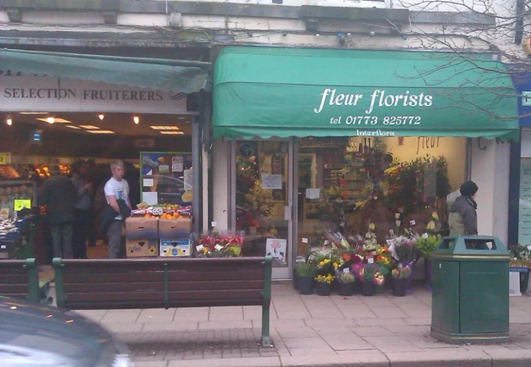 two people in front of the flower shop