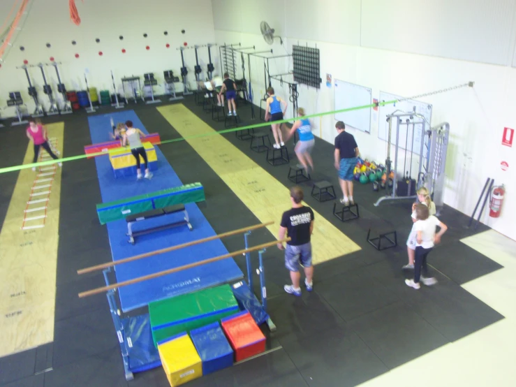 a group of people are playing on the gym floor