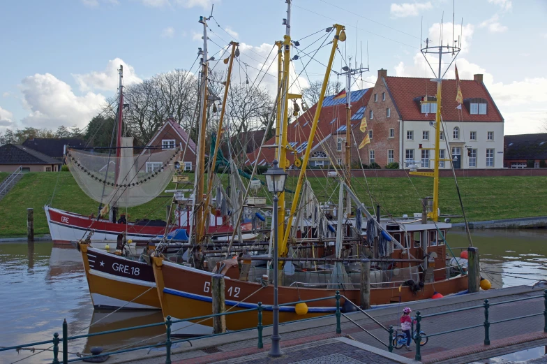 a harbor with boats and some houses in the background