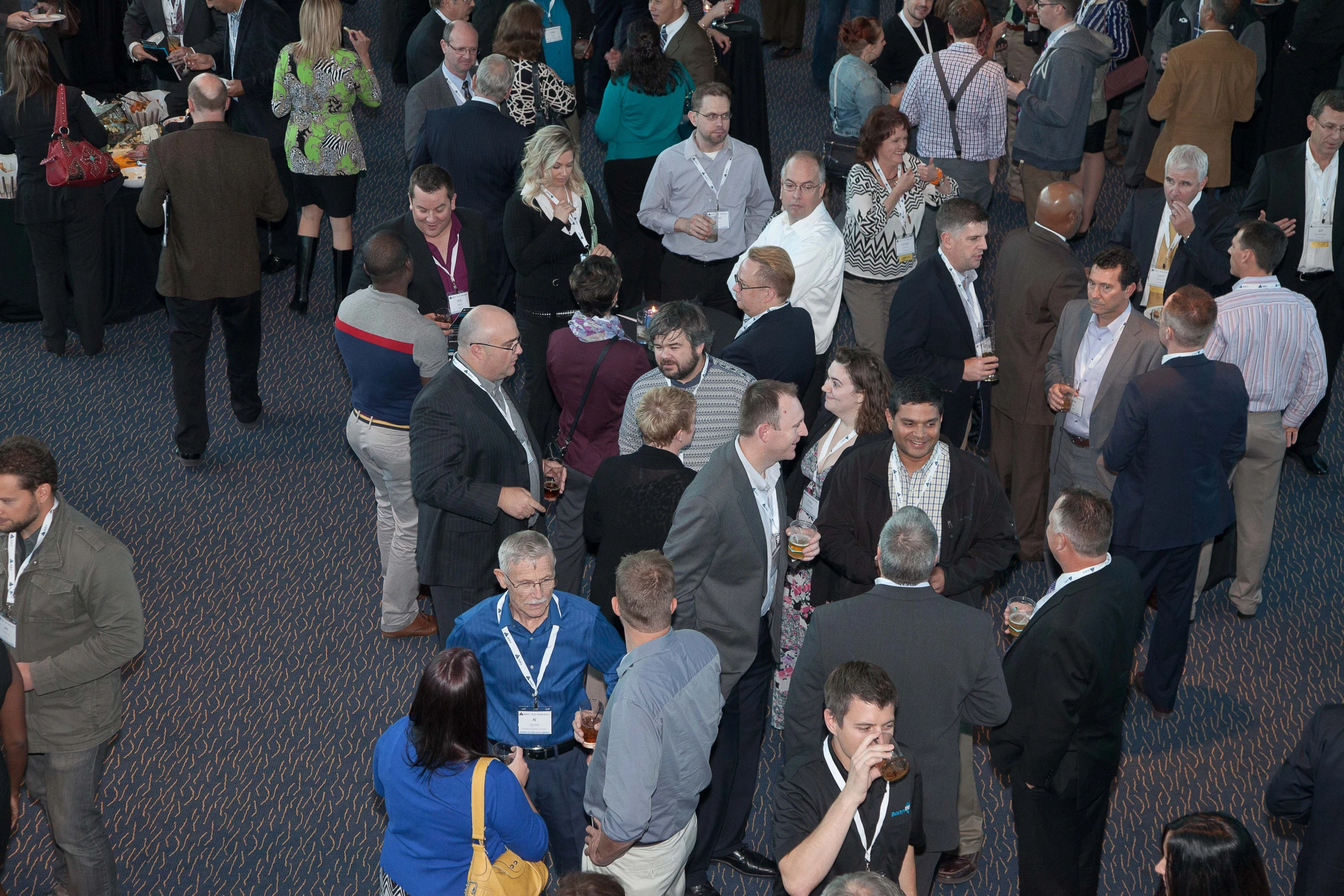 several groups of people walking through a crowded room