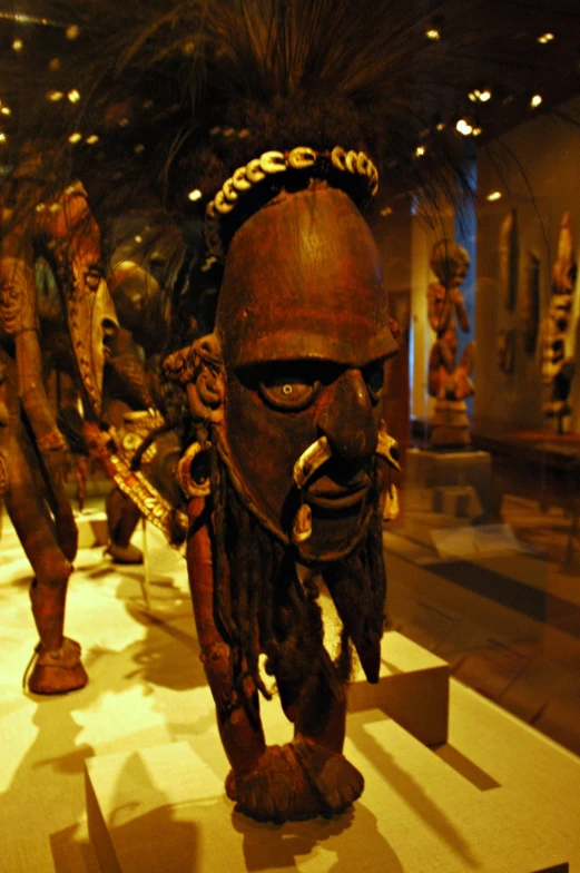 a group of statues that include men with beards and masks