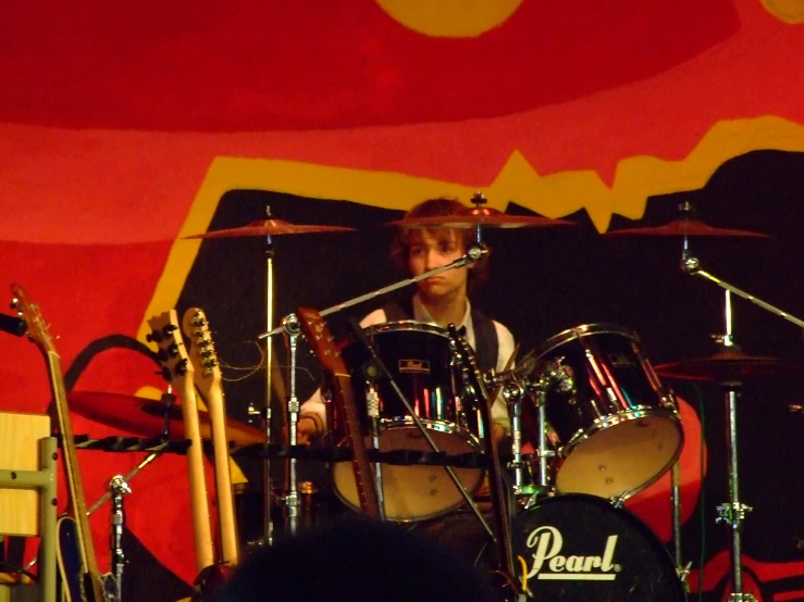 the drums player is drumming for a group