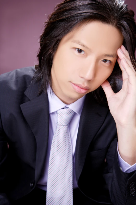 a close - up of a person in a suit and tie