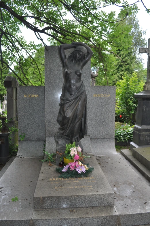 a statue next to a memorial in a park