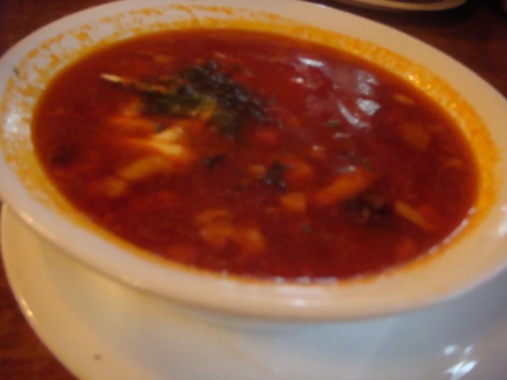 a close up of a bowl of soup on a plate
