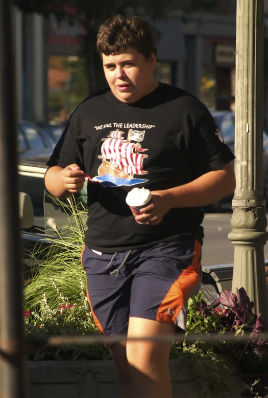 a  is walking and holding some paper