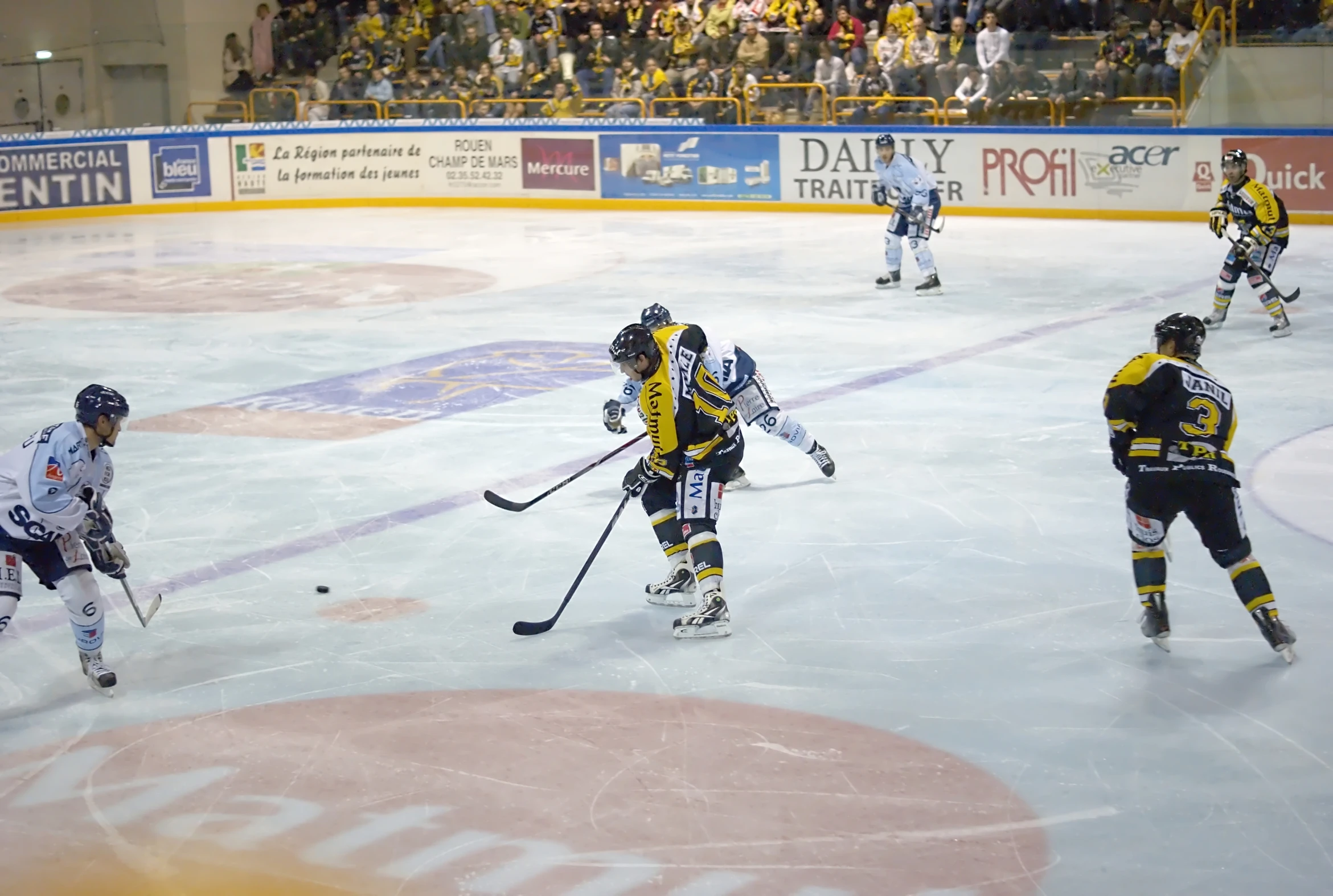 three ice hockey players are playing on an ice rink