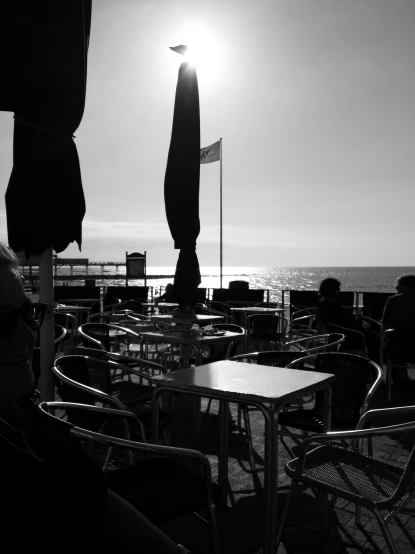 black and white image of patio seating area overlooking the ocean