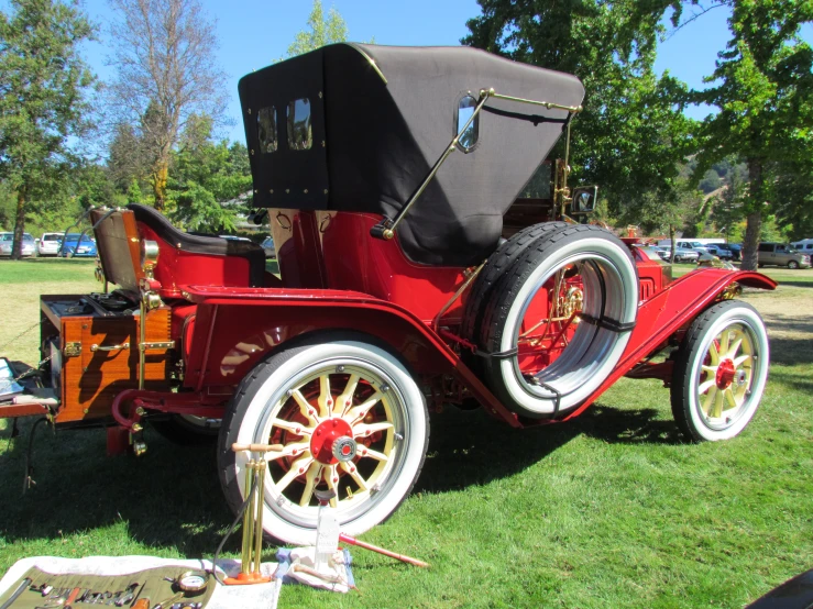 an old fashioned automobile on display in a park