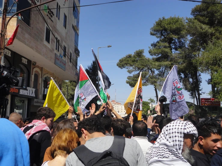 the crowd is holding up many flags and watching soing