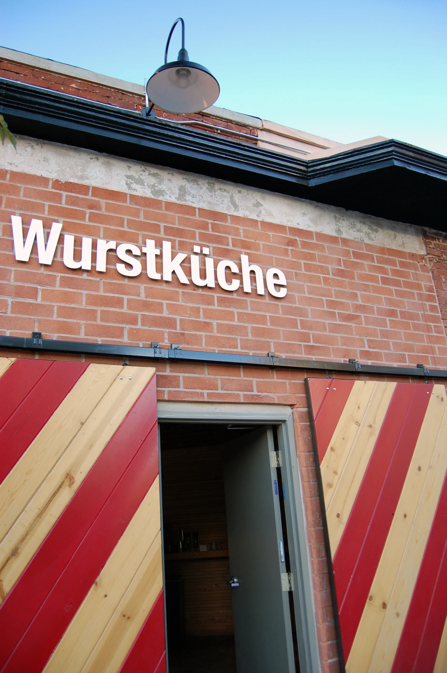 an outside view of a small brick building with windows