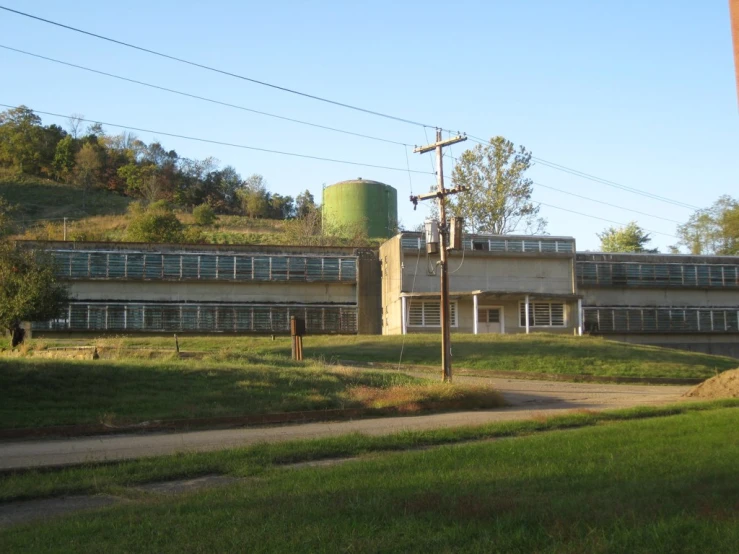 old building with large round green tank above