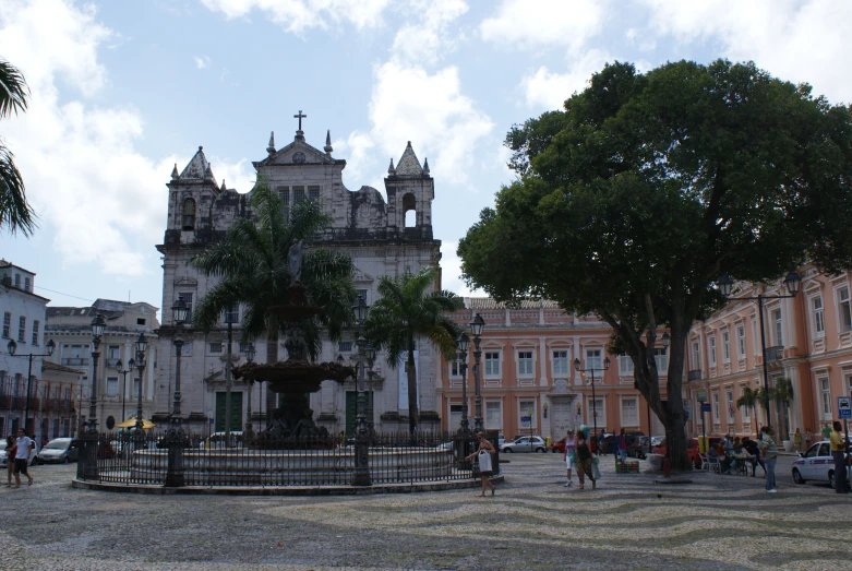 an old church on the corner with people in front