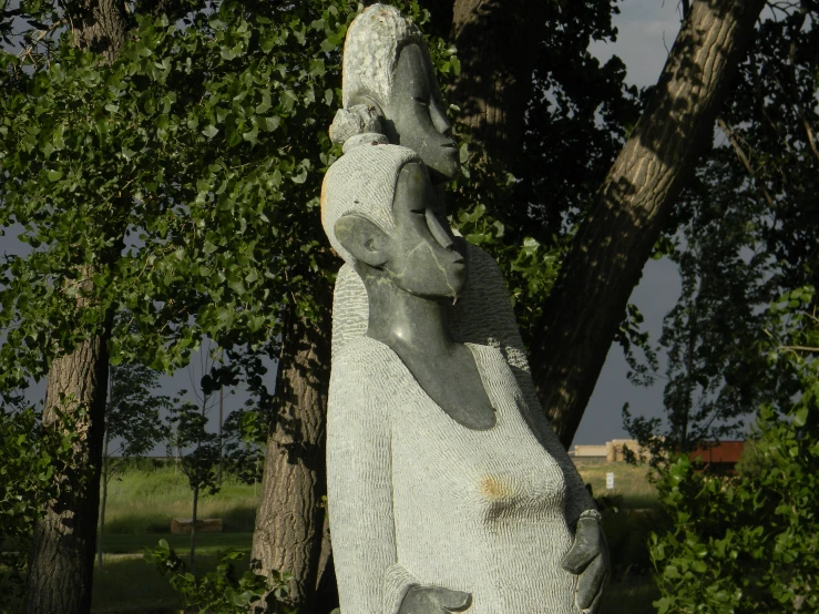 a sculpture sitting in the middle of a forest