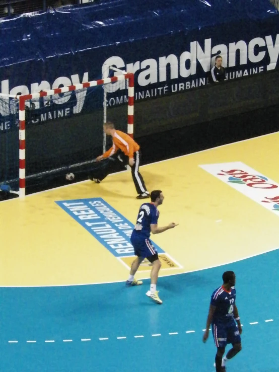 the men play volleyball in a professional match