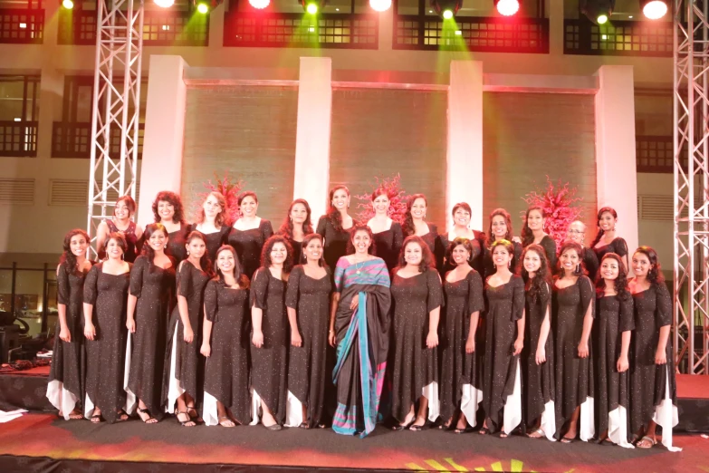 a choir with a woman dressed in black and an all white outfit