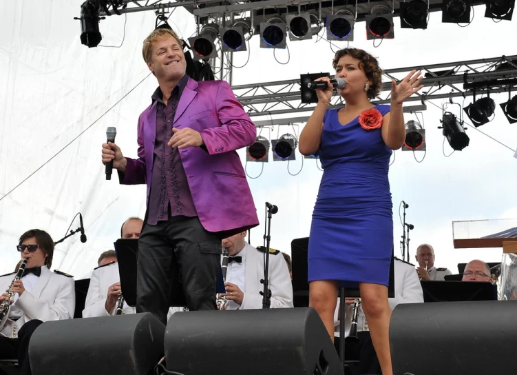 a man and a woman standing on a stage