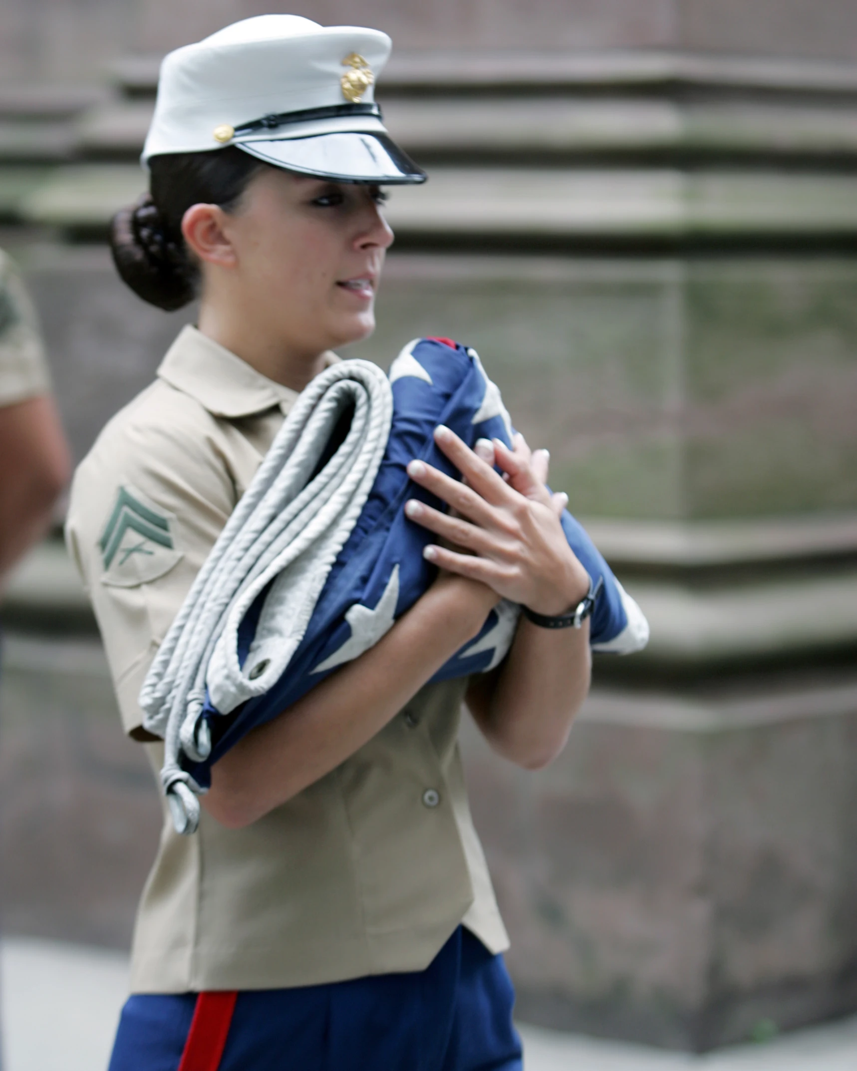 a woman in a uniform holds a blue bag