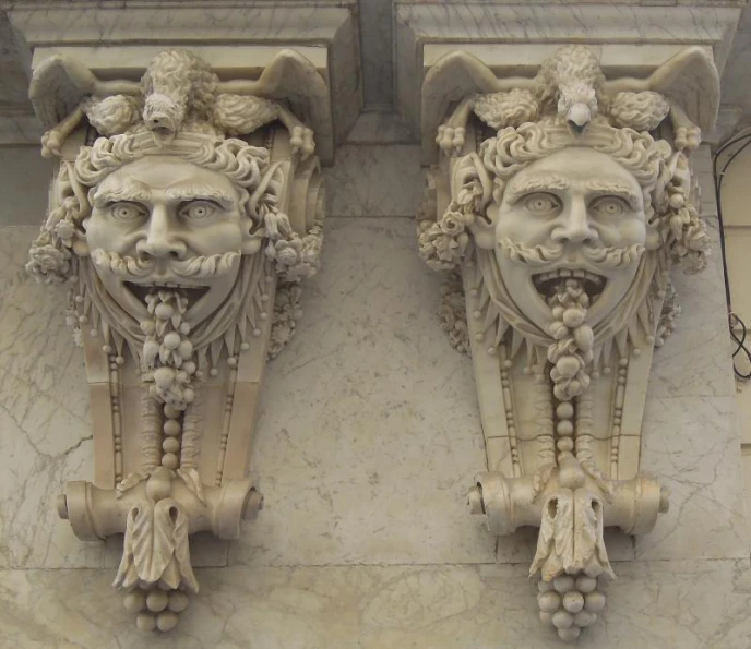 the two elaborate faces on this building depict evil spirits