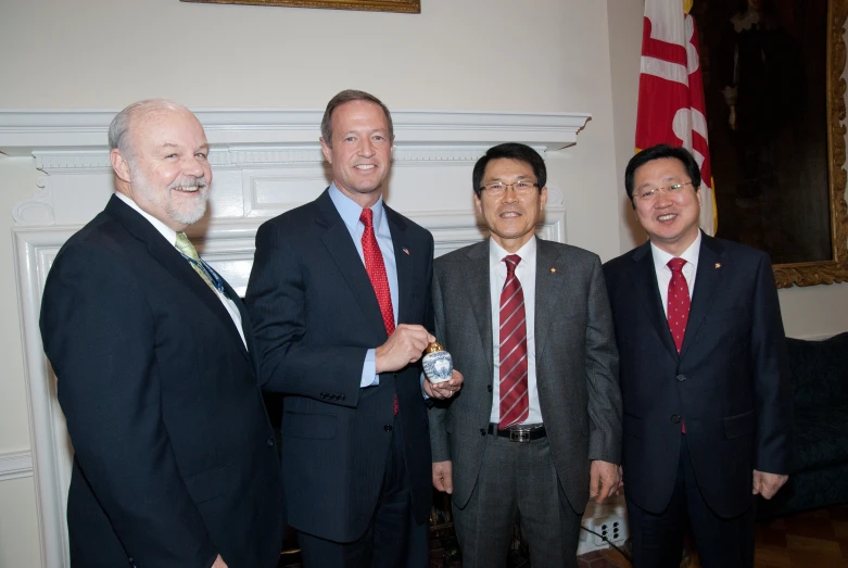 a group of business men standing next to each other