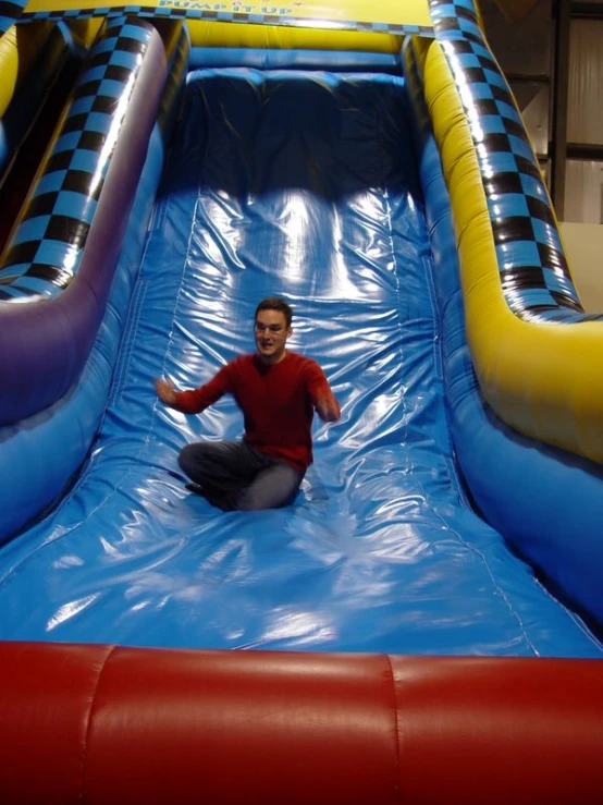 a man that is sitting down on a slide
