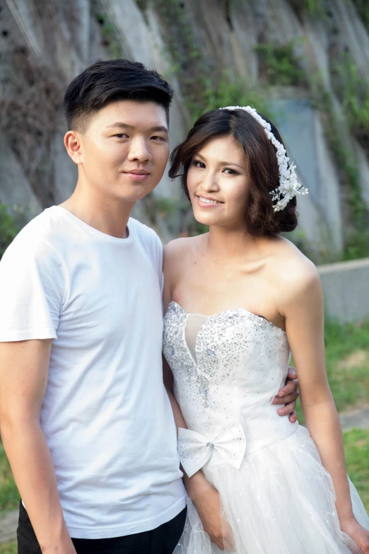 a married couple poses together by a waterfall