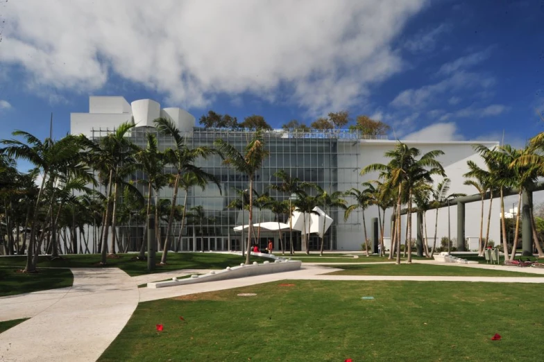 a building sitting in the middle of palm trees