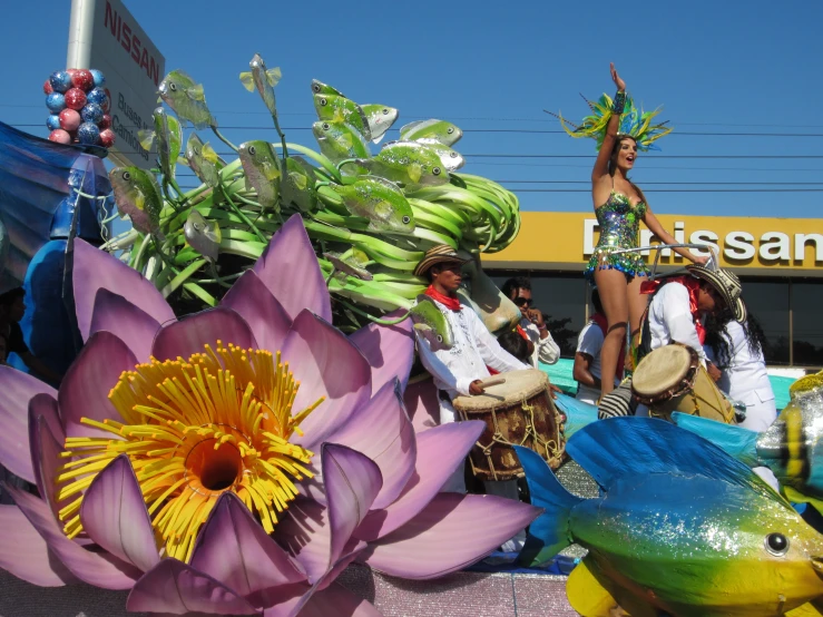 a man and woman float next to a dragon statue