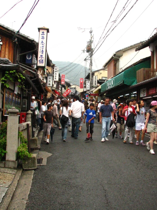 a group of people lined up on the sidewalk