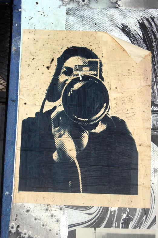 an old man with a camera has been stenciled on a piece of wood